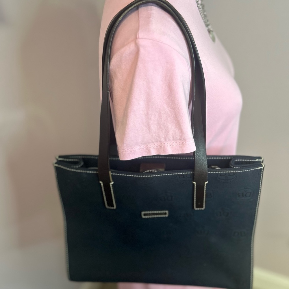 Dooney and Bourke purse. Barely used. Navy with brown leather straps.